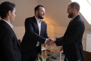 Two businessman shaking hands at a VIP meeting.