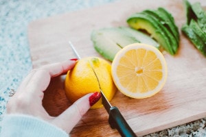 Cutting of lemon with Knife on a cutting board