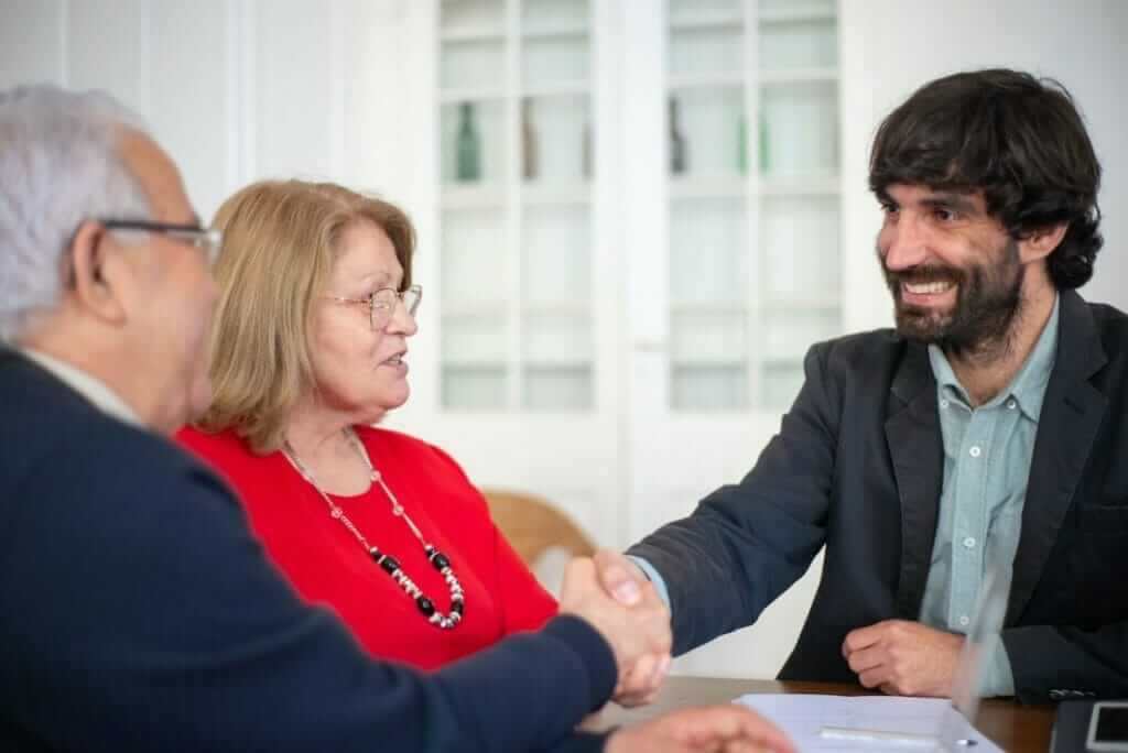 a couple shaking hands with business consultant