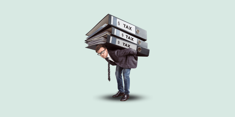 a man lifting heavy tax files on his shoulders.
