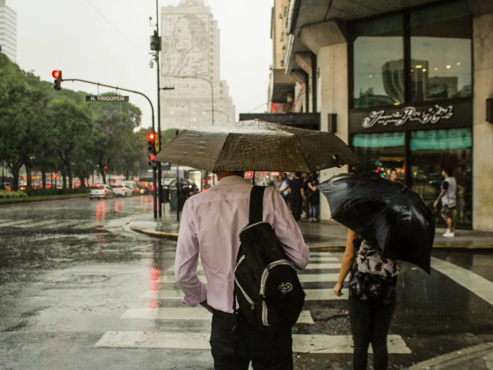 Man wearing pink Dress Shirt Holding an Umbrella and a Bag Pack crossing road!